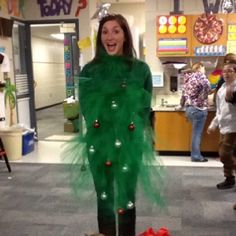 a woman dressed as a christmas tree in an office