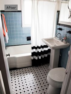 a small bathroom with black and white tile on the floor