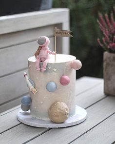 a birthday cake decorated with an astronaut theme