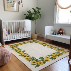 a baby's room with sunflowers on the rug and a crib