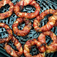 bacon rings are being cooked on the grill