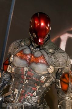 a close up of a person in a suit and helmet with metal parts on his body