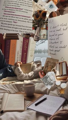 a person laying in bed with books and papers