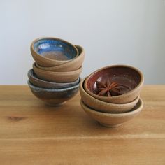 four bowls stacked on top of each other, one with an orange star in the middle