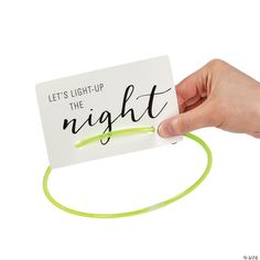 a hand holding a white card that says let's light - up the night