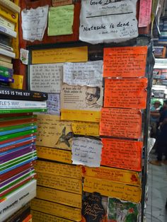 many books are stacked on top of each other in front of a book store display