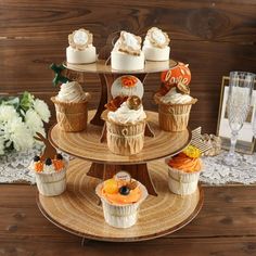 a three tiered tray with cupcakes and other desserts on top of it