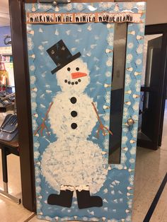 a snowman made out of paper on a door