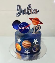 a space themed birthday cake with the name julia on it's top and outer planets