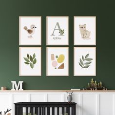 a baby's room with green walls and pictures on the wall, including a crib