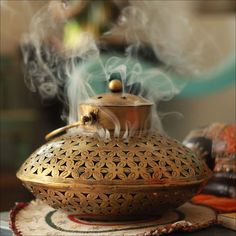 a tea pot with steam rising from it