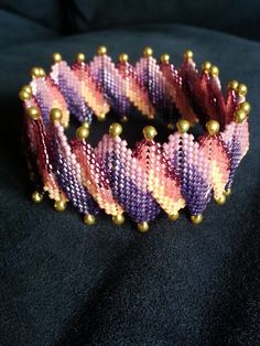 a close up of a bracelet on a black surface