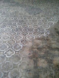 an old cement floor with white designs on it