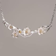 Embrace the timeless elegance of nature with our Plum Blossom Necklace, a stunning piece that captures the delicate beauty of the plum blossom in sterling silver with gold-plated accents. The plum blossom, revered for its resilience and grace, symbolizes strength, perseverance, and the promise of renewal. Each petal is intricately crafted to reflect the flower's natural charm, set on a beautifully detailed branch that wraps gracefully around your neck. Whether worn alone or paired with matching Elegant Flower Necklace Spring Gift, Elegant Spring Flower Necklace As A Gift, Elegant Spring Flower Necklace As Gift, Elegant Spring Flower Necklace Gift, Delicate Flower Necklaces For Spring, Delicate Flower Necklace For Spring, Elegant Flower Necklace For Spring, Elegant Flower Charm Necklace For Spring, Elegant Spring Flower Decorated Necklace