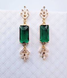 **All orders come with tracked shipping so you can be assured that you will receive your item** PLUS **Free shipping on orders over $35 USD for US customers** High quality champagne gold plated Gatsby style earrings and necklace set with rectangle emerald cubic zirconia stones.  The chain is 1mm thick and 46cm long. It is easily adjustable to make it shorter to your desired length simply by pulling on the chain through the round gold bead. It also has 2 removal options - using the clasp or pulli Glamorous Green Jewelry For Anniversary, Green Jewel Earrings For Wedding, Green Jeweled Earrings For Wedding, Glamorous Green Jewelry As A Gift, Glamorous Green Jewelry Gift, Art Deco Green Jewelry For Anniversary, Art Deco Dangle Jewelry For Weddings, Green Evening Jewelry, Art Deco Emerald Jewelry For Formal Occasions