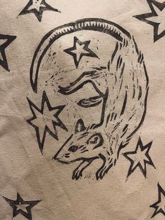 a black and white drawing of a rat in the middle of stars on a piece of paper