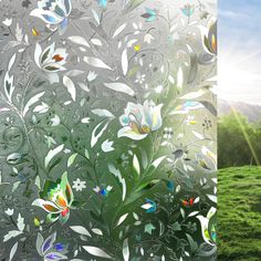 an image of a window with flowers and grass in the foreground, and sunlight shining through it