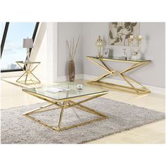 two tables with glass top and gold metal frame, one on carpeted floor in front of window