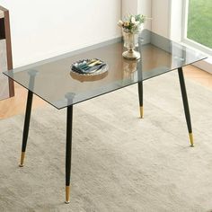 Elevate the look of your dining room with this ultra-modern table. Its compact, rectangular design makes it a great choice for a space-conscious home. It has straight, round legs made of iron that supports a transparent top made from tempered glass. We love the airy, light look that this table brings to your space. And, imagine it with a pretty faux fur dining chairs. Best of all, its so easy to clean or dust. Color: Clear. Kitchen Table For 4, Fur Dining Chair, Rectangular Kitchen Table, Wooden Extendable Dining Table, Modern Glass Dining Table, Coffee Table Small Space, Rectangular Kitchen, Transparent Top, Glass Dining Table