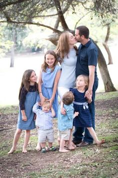 a family posing for a photo in the park