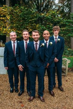 a group of men in suits standing next to each other