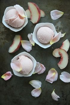 three bowls filled with ice cream next to sliced peaches