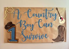 a sign that says a country boy can survive with cowboy boots and a guitar on it