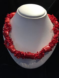 this coral necklace is designed with three strands joining intermittently to one large coral bead. I Elegant Adjustable Coral Necklace, Elegant Adjustable Red Coral Necklace, Coral Gemstone Bead Necklace In Red Coral, Single Strand Red Coral Necklace, Elegant Red Coral Necklace With Lobster Clasp, Elegant Double Strand Coral Necklace, Red Coral Gemstone Beads Necklace In Coral, Adjustable Red Coral Gemstone Beads Jewelry, Adjustable Single Strand Beaded Necklace In Red Coral