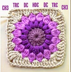 a crocheted square with a purple flower on it and the words ch3