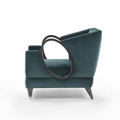 a green chair with a circular design on it's arm and back, sitting in front of a white background