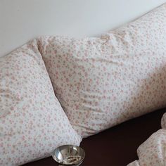 two pillows and a bowl on a table