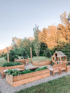 an outdoor vegetable garden with wooden benches and raised beds