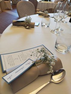 the table is set with silverware, napkins and place settings for an event