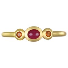 A vibrant oval shaped ruby flanked by sparkling mandarin garnets. This three stone ring is beautifully crafted, bezel set and matte-finished. Wear alone or stacked with other rings to elevate your individual style! Handcrafted in 18k green gold, Faye Kim’s modern design conveys understated elegance and a truly stylish, everyday look. Size 7 All pieces designed and handmade in the US. Model photographed wearing similar style stack rings Signature Collection: non negotiable Gold Stacking Rings, Stack Ring, Three Stone Ring, Gold Ring Stack, Three Stone Rings, Cluster Ring, Individual Style, Three Stone, Stone Ring