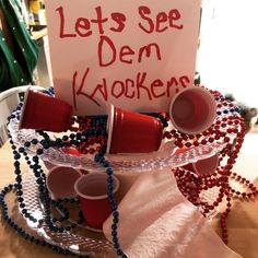 a sign that says let's see dem kookers with cups and beads