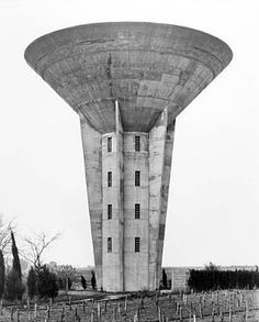 an old black and white photo of a water tower