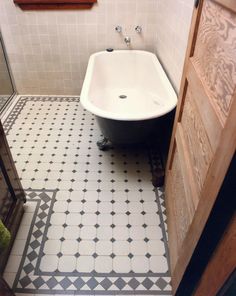 a bath tub sitting in the middle of a bathroom next to a sink and mirror