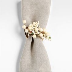 a white flower on top of a beige cloth