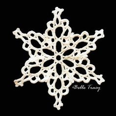 a white snowflake ornament on a black background