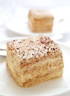 a piece of cake sitting on top of a white plate next to another slice of cake