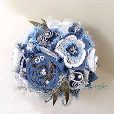 a bridal bouquet with blue and white flowers on the bottom, attached to a wall