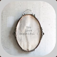 a round object with the words you look beautiful written on it's back side