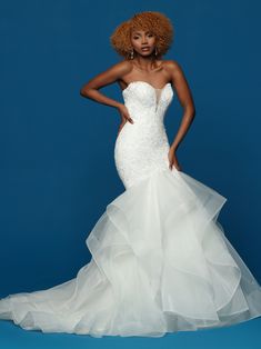 a woman in a white wedding dress posing for a photo with her hands on her hips