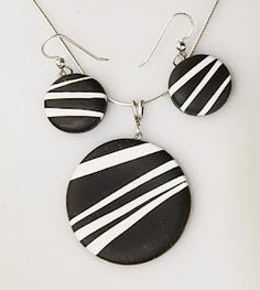 two black and white striped earrings hanging from silver earwires on a white background