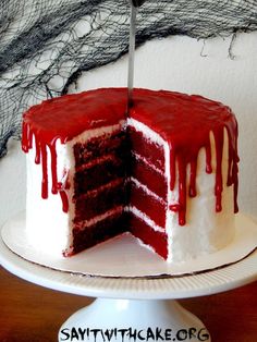 a red velvet cake with white frosting and dripping icing