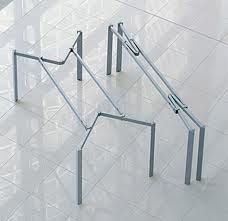 three metal handrails on the floor in an empty room with white tile floors