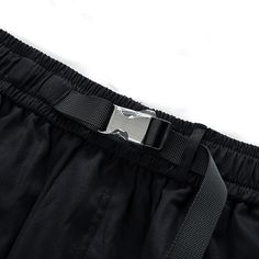 Exude confidence and sophistication in these cyberpunk-influenced baggy techwear pants. Introducing the Tech Cargos, an innovative and stylish fusion of performance and fashion that transcends the ordinary. These men's cargo pants are the ultimate expression of elegant multifunction, designed for young urban dwellers who seek to elevate their wardrobe and make a statement. Constructed with a sleek elastic waistband, our cuffed cargo pants boast a sophisticated metallic clamping buckle, ensuring a perfect fit tailored to your form. These baggy tech pants feature a generous cargo pocket with drawstrings at each knee, providing ample storage while enhancing your style. The elegant back pocket offers additional storage and style, while the high-performance tech clothing inspiration, blended wi Functional Cargo Pants For Streetwear With Belt Loops, Black Nylon Techwear Pants, Techwear Parachute Pants For Streetwear, Techwear Cargo Pants With Functional Pockets, Streetwear Black Parachute Pants With Functional Pockets, Black Cyberpunk Cargo Pants For Streetwear, Black Parachute Pants For Streetwear With Functional Pockets, Black Parachute Pants With Functional Pockets For Streetwear, Black Baggy Techwear Parachute Pants