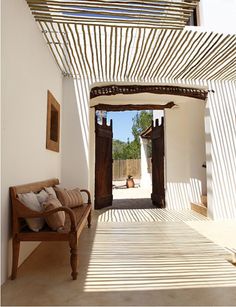 the inside of a house with an open door and wood flooring on the outside