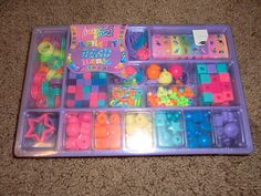 a plastic tray filled with lots of colorful toys