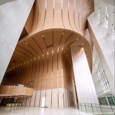 the inside of a large building with lots of wood and white tiles on the walls